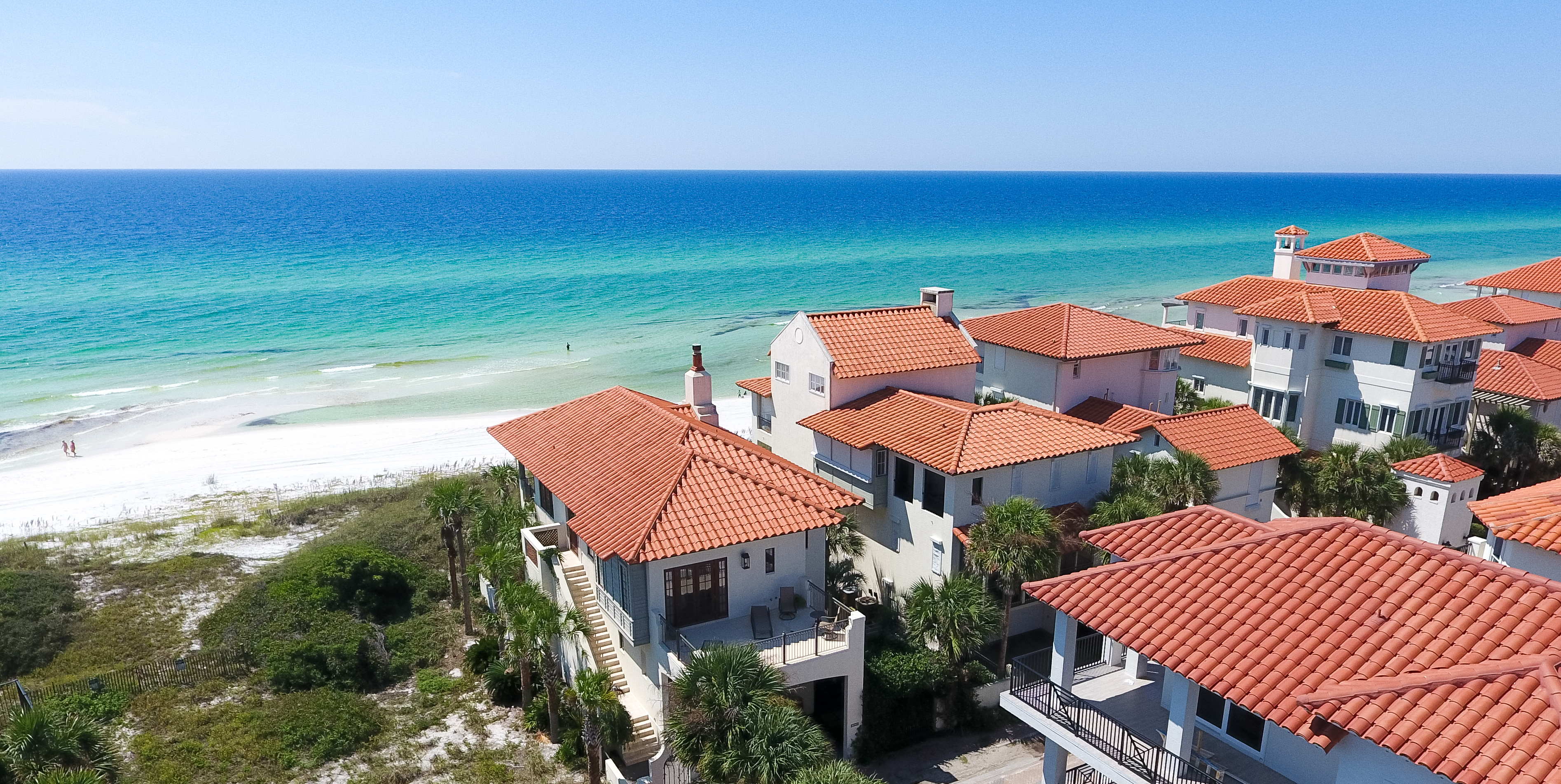 An aerial view of some of the gulf front homes in Vizcaya with the brilliant blue guy in the background
